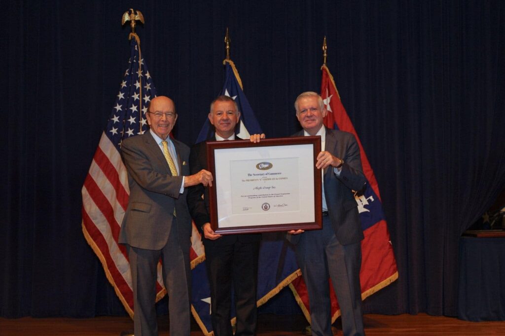 Jales A. De Mello posing with the President’s “E” Award for Exports after the Ceremony